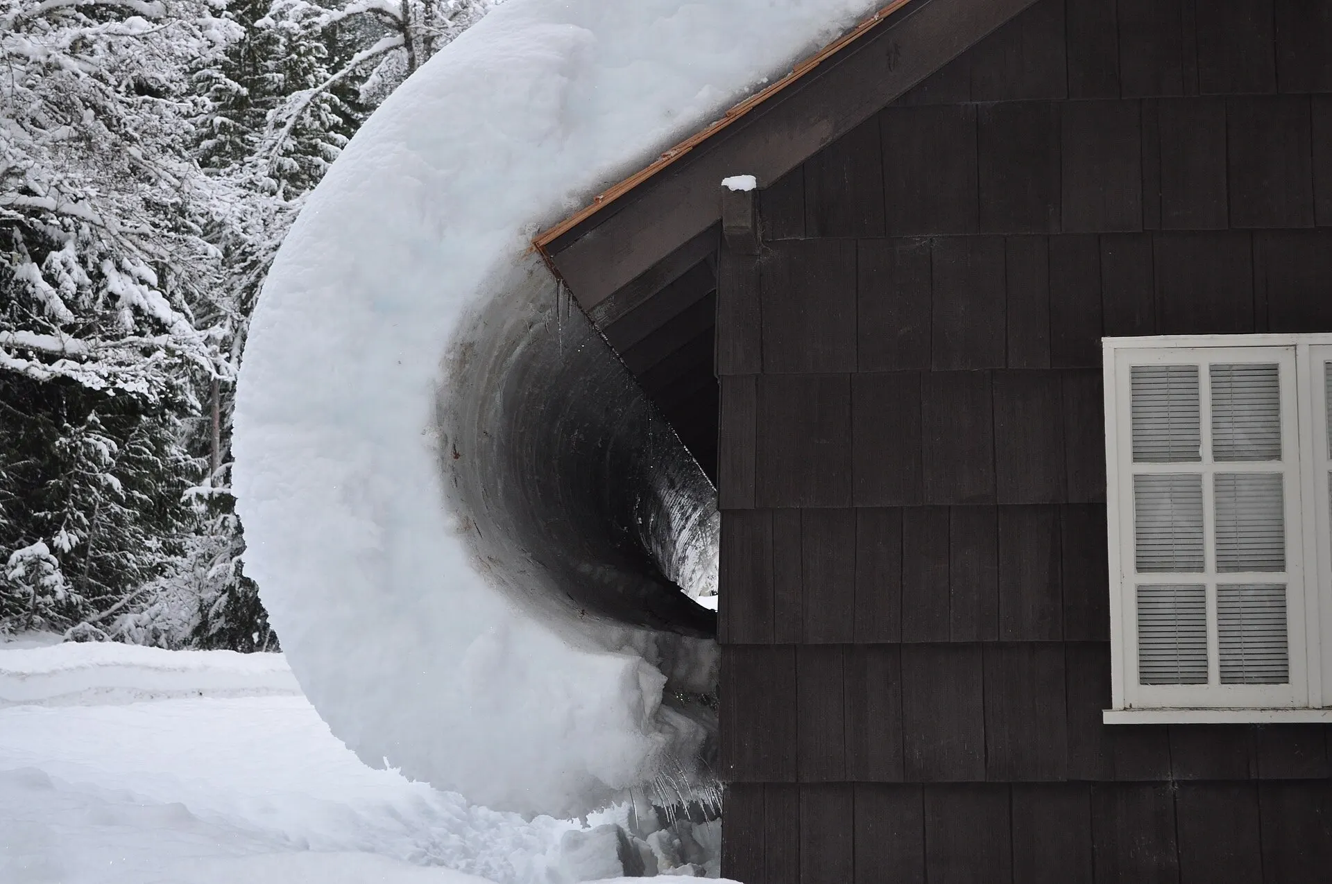 Snow sliding off the roof of a Georgian Bay home in winter
